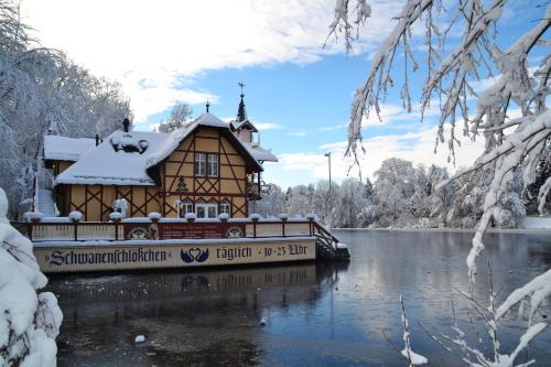 a house on a boat on a lake in the snow at Altstadt-Hotel in Freiberg