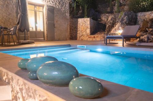 a swimming pool with balls in the middle of it at Dafni by Vintage Travel in Dhefaranáta