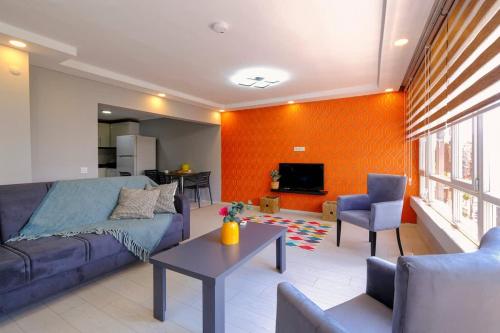 a living room with a blue couch and a tv at Sea View Flat in Kaleici Old Town Near Sea Park in Antalya