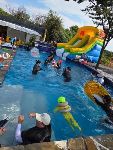 a group of people in a pool at a water park at Nobless Pension in Taean