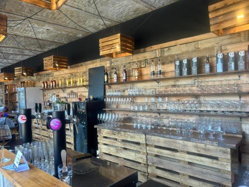 a bar with many glasses on a wall at L'Escapade Rétro in Namur