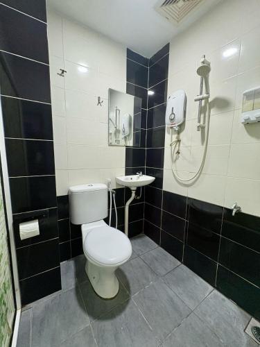 a bathroom with a toilet and a sink at Gemilang Star Hotel in Port Dickson