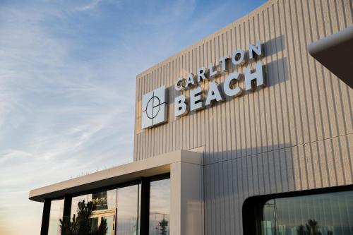 a building with a sign on the side of it at Carlton Beach in Scheveningen