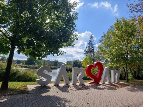 a sign for a park with two red hearts at Atmoszféra Apartman in Sárvár