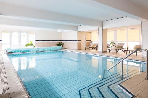 a large swimming pool in a building at Carlton Beach in Scheveningen