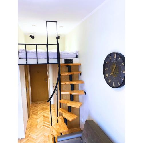 a room with two bunk beds and a clock at Studio LOFT right in the center in Skorka
