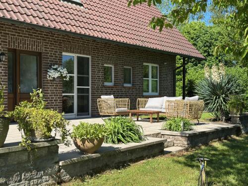 a patio with wicker furniture in front of a house at Apartments Mester in Xanten