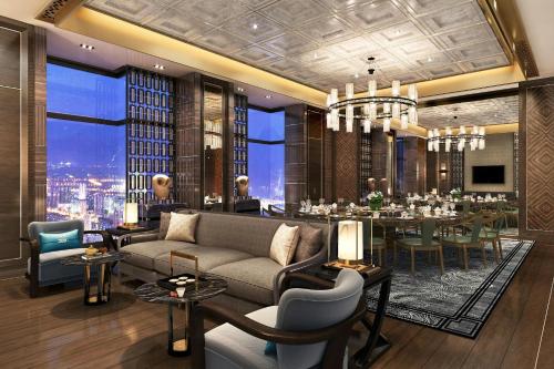 a living room with a couch and a dining room at JW Marriott Hotel Xi'an in Xi'an