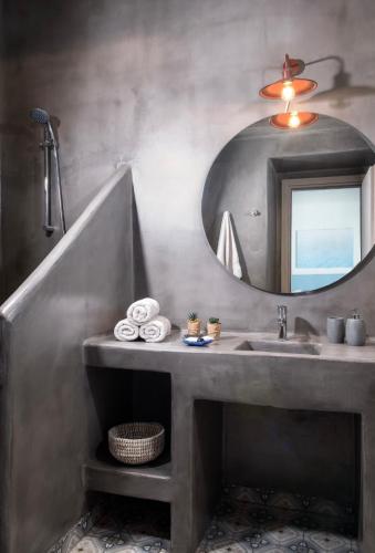 a bathroom with a sink and a mirror at Ionian Mansion in Antipata
