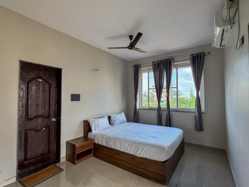 a bedroom with a bed and a window at RK Homes Service Apartments in Sancoale
