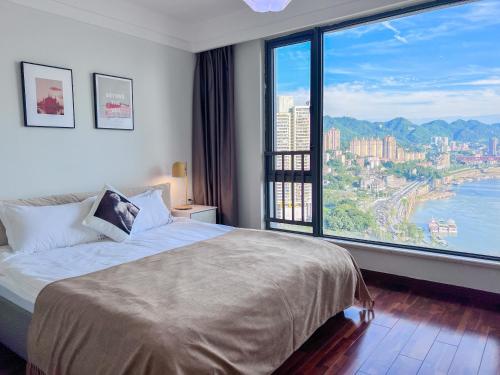 a hotel room with a bed and a large window at Chongqing Yifang B&B in Nan'an