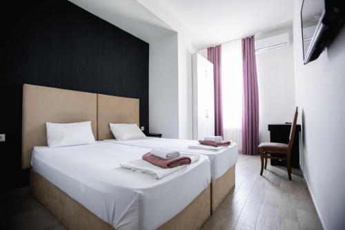 a bedroom with a bed with two towels on it at kutaisi hostel hub in Kutaisi