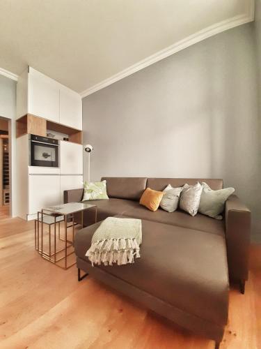 a living room with a couch and a table at Fürstenhof Sassnitz - PANORAMA103 in Sassnitz