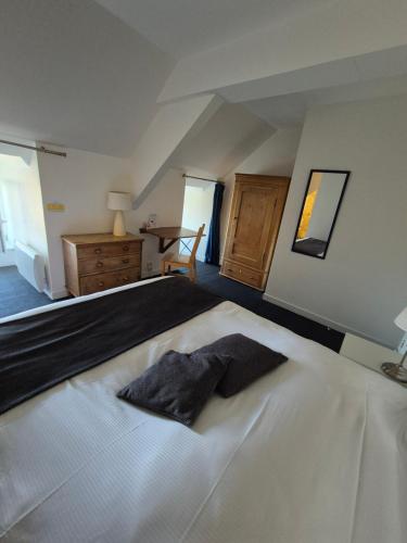 a bedroom with a bed with a pillow on it at La Roche du Marais in Omonville-la-Petite