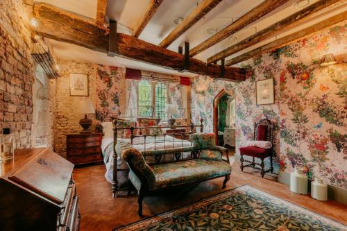 a bedroom with a bed and floral wallpaper at Salmestone Grange in Margate