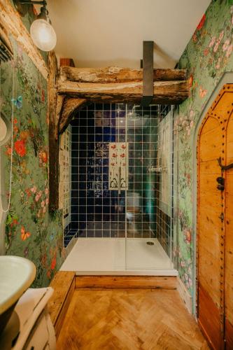 a bathroom with a shower with a glass door at Salmestone Grange in Kent