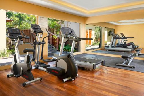 a gym with several treadmills and elliptical machines at Element Bali Ubud in Ubud