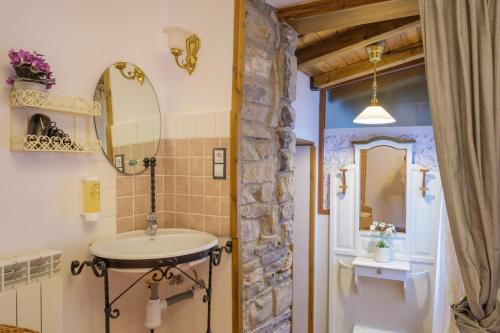 a bathroom with a sink and a mirror at Casa Maza Apartamentos in Biescas