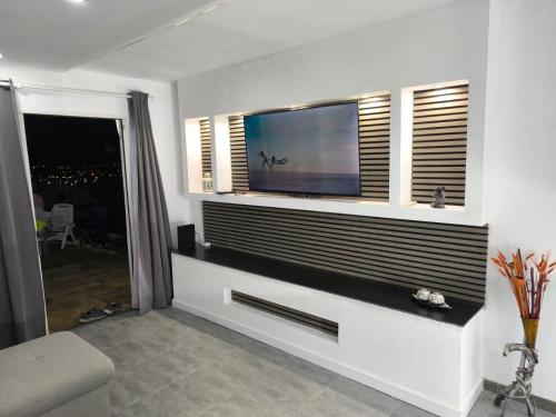 a living room with a flat screen tv on a wall at Bungalow Vista Dorada in Sonnenland