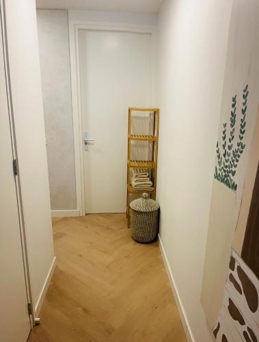 a hallway with white walls and wooden floors at B&B s12 in Doetinchem