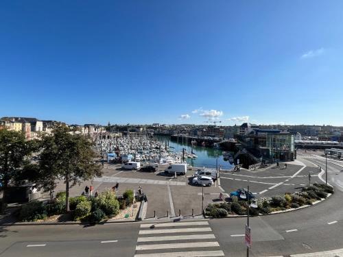 a view of a harbor with boats in a marina at LOGIS Hôtel & Restaurant - Les Arcades in Dieppe