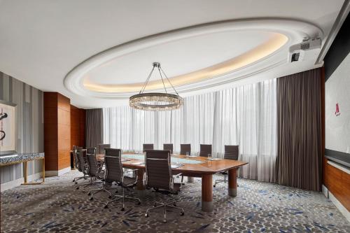 a conference room with a long table and chairs at Shanghai Marriott Marquis City Centre in Shanghai