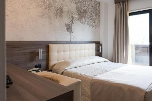 Postel nebo postele na pokoji v ubytování Hotel Regent's