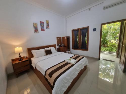 a bedroom with a large bed and a window at D'Jongke Village in Beran-kidul