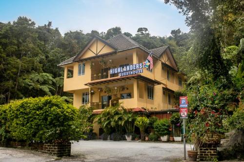 a large yellow building with a sign on it at Highlanders Garden Guesthouse at Arundina Cameron Highlands in Cameron Highlands