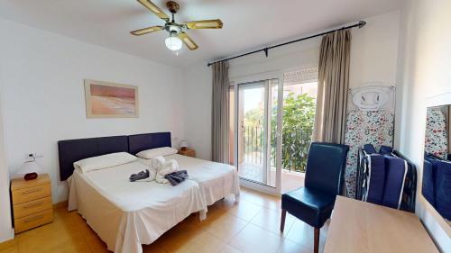 a bedroom with a bed and a chair and a window at Ginkgo 302891-A Murcia Holiday Rentals Property in Los Martínez