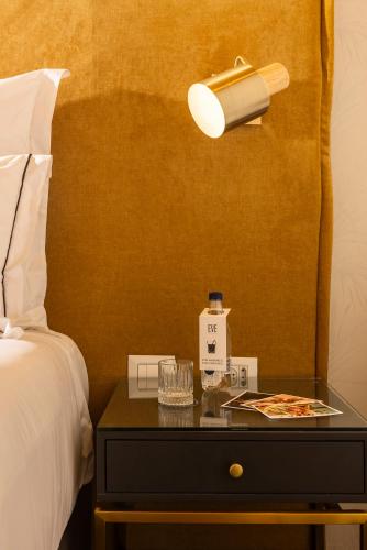 a bedroom with a bed and a table with a lamp at EVE Eilat by Adam Hotels in Eilat