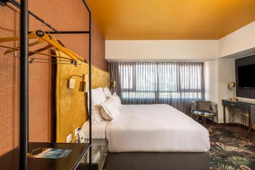 a hotel room with a bed and a desk at EVE Eilat by Adam Hotels in Eilat