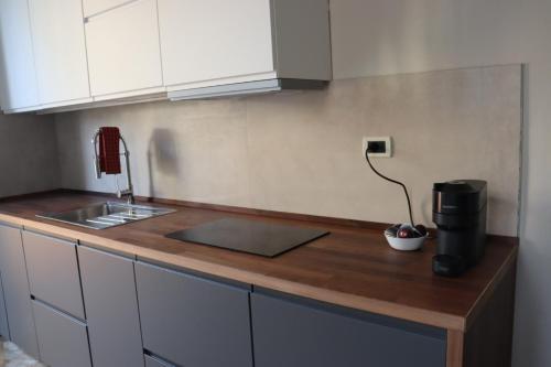 a kitchen with a counter with a coffee maker on it at Terrazza Sonnino in Pisa
