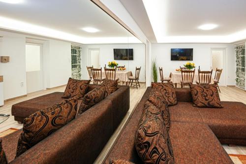 a large living room with a couch and a table at Sunrise Airport Inn - Free Parking in Budapest