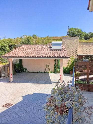 a pavilion with a bench sitting on top of it at Villa Panorama Pool & Garden in Trevignano Romano