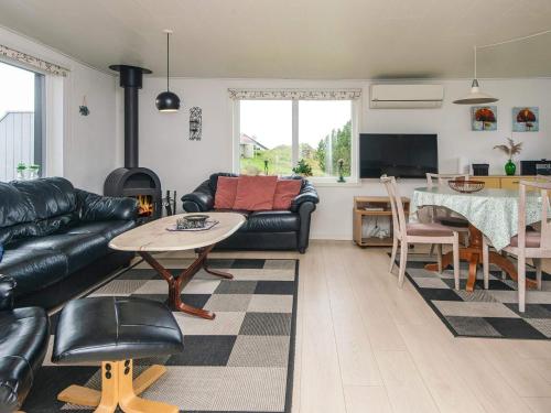 a living room with a couch and a table at 6 person holiday home in Rømø in Bolilmark
