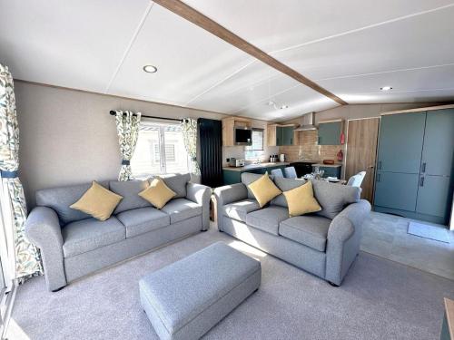 a living room with two couches and a kitchen at Modern Caravan 2025 with Decking in Morecambe