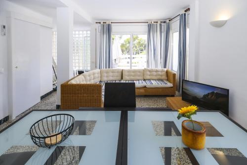 a living room with a couch and a table at Casa CODOLAR in Salou