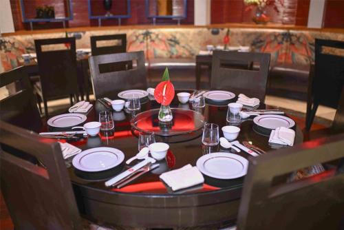 a table with plates and napkins on top at Radisson Blu MBD Hotel Noida in Noida