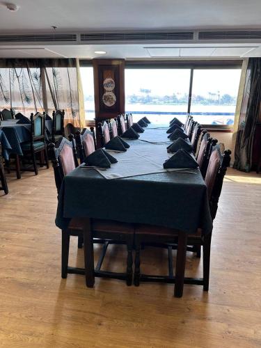 a dining room with a table and chairs in a room at الباخرة ريفر بوت نايل كروز in Cairo