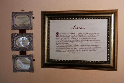 a picture of a sign on a wall with two mirrors at Luxury Guesthouse Pantheon in Palaios Panteleimon
