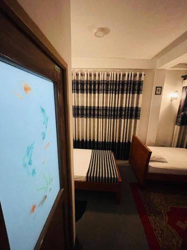 a room with a projection screen and a bed at 360 City View in Badulla