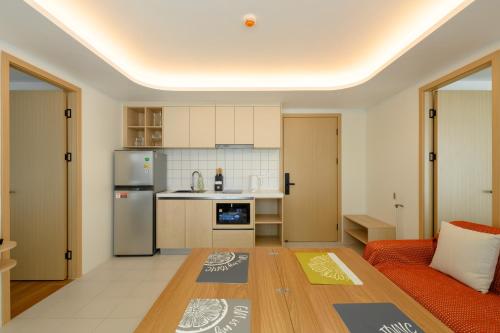 a kitchen with a couch and a table in a room at Fantasea Condo Kamala A210 2BDRM by Phuket Sabay Rent in Kamala Beach