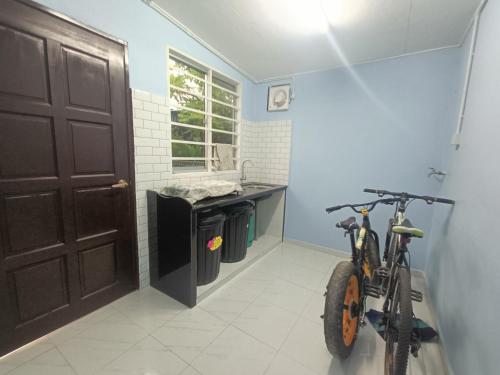 a bike parked in a bathroom next to a sink at Teratak Taha in Kepala Batas