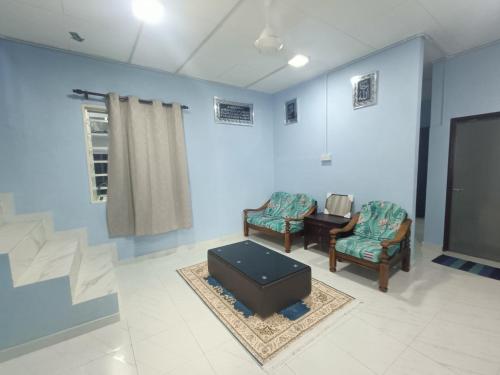 a waiting room with two chairs and a tv at Teratak Taha in Kepala Batas