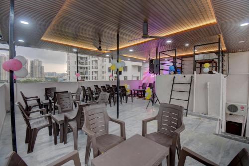 a room with chairs and tables and a bar with a room with at Quite Room in pune city in Méribel Village