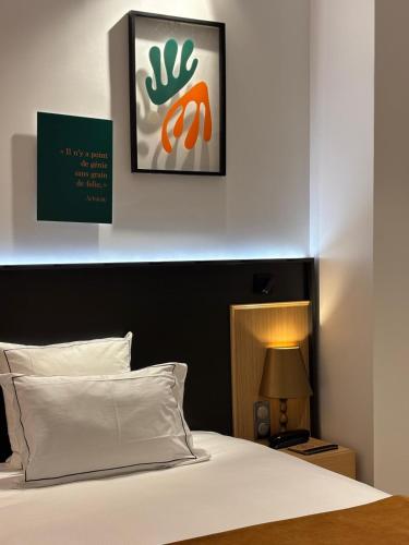 a bedroom with a bed and a picture on the wall at Star Champs-Elysées in Paris