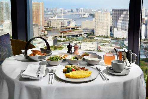 a table with plates of food on it with a view at JW Marriott Hotel Tokyo in Tokyo