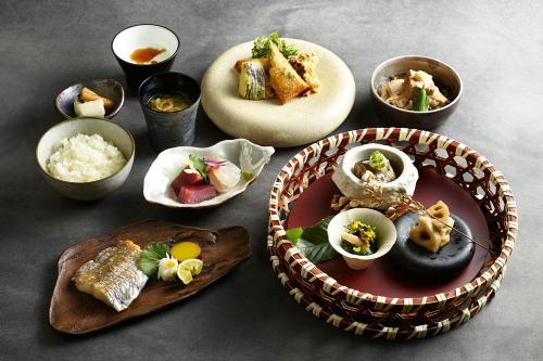 a table with plates of food and bowls of food at JW Marriott Hotel Tokyo in Tokyo