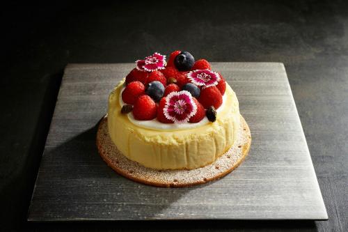 a cake with berries on top on a table at JW Marriott Hotel Tokyo in Tokyo